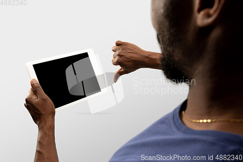 Image of Close up male hands holding smartphone with blank screen during online watching of popular sport matches and championships all around the world. Copyspace for ad