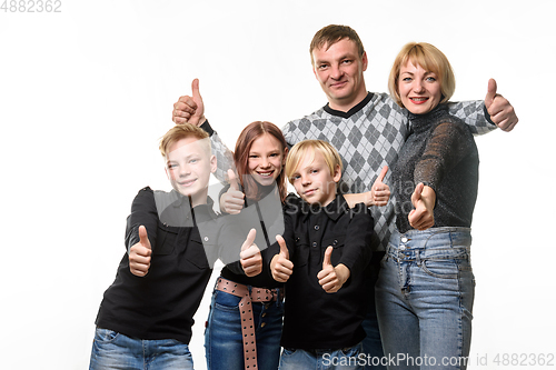 Image of Portrait of an ordinary large family, everyone shows a thumbs up and joyfully looks into the frame