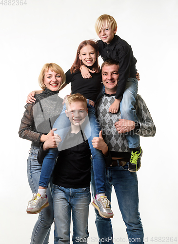 Image of Portrait of a large family with teenagers in casual clothes on a white background