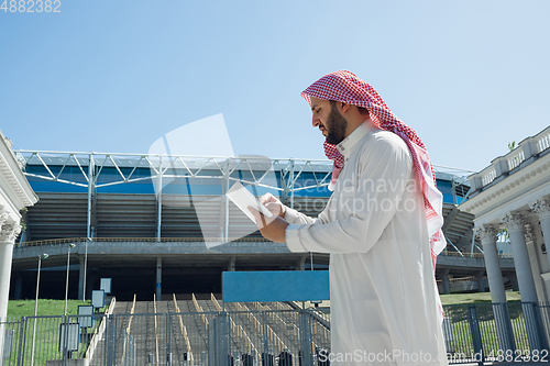 Image of Smiling rich arabian man\'s buying real estate in the city