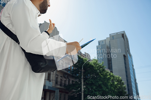 Image of Smiling rich arabian man\'s buying real estate in the city