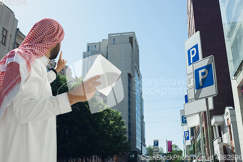 Image of Smiling rich arabian man\'s buying real estate in the city