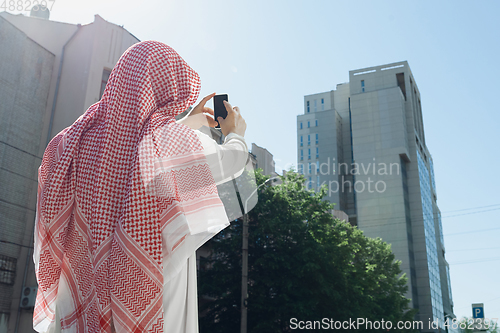 Image of Smiling rich arabian man\'s buying real estate in the city