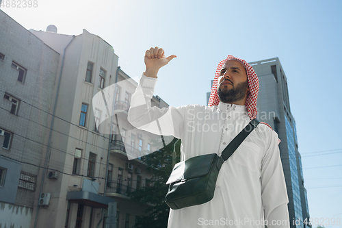 Image of Smiling rich arabian man\'s buying real estate in the city