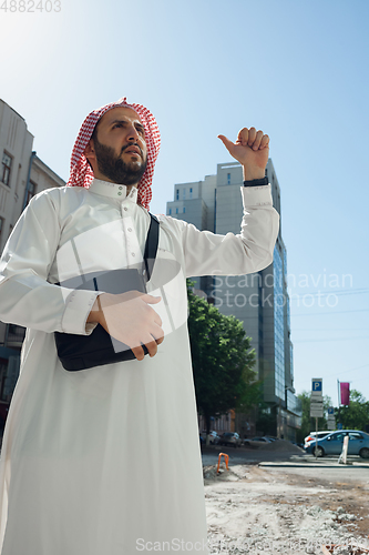 Image of Smiling rich arabian man\'s buying real estate in the city