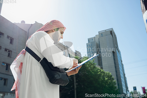 Image of Smiling rich arabian man\'s buying real estate in the city