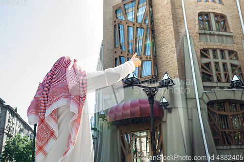 Image of Smiling rich arabian man\'s buying real estate in the city