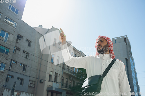 Image of Smiling rich arabian man\'s buying real estate in the city