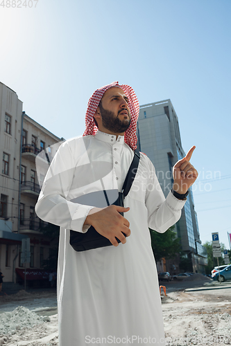 Image of Smiling rich arabian man\'s buying real estate in the city