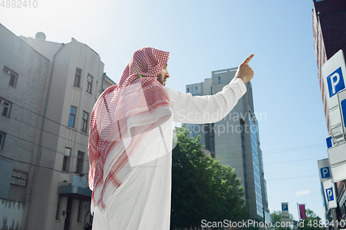 Image of Smiling rich arabian man\'s buying real estate in the city