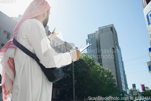 Image of Smiling rich arabian man\'s buying real estate in the city