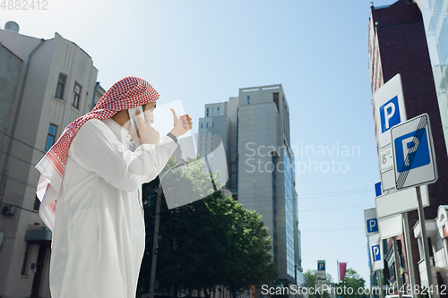 Image of Smiling rich arabian man\'s buying real estate in the city