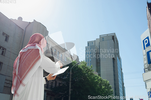 Image of Smiling rich arabian man\'s buying real estate in the city