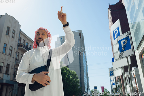 Image of Smiling rich arabian man\'s buying real estate in the city