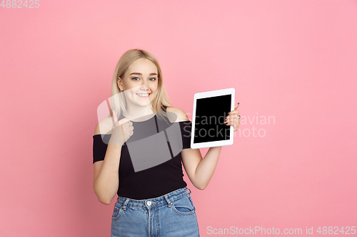 Image of Portrait of young caucasian woman with bright emotions on coral pink studio background