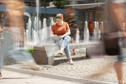 Image of Caucasian female inclusive plus-size model in her daily routine. Realness, tolerance, lifestyle