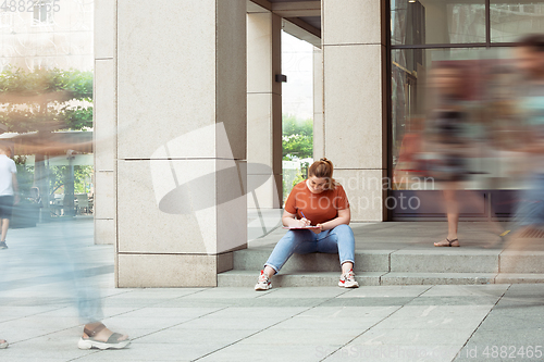 Image of Caucasian female inclusive plus-size model in her daily routine. Realness, tolerance, lifestyle