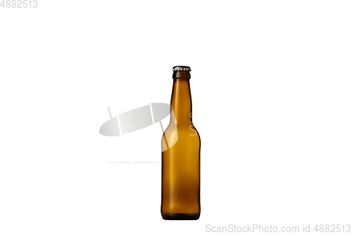 Image of Empty golden colored beer bottle. Isolated on white studio background