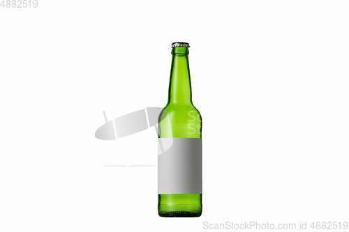 Image of Empty green colored beer bottle. Isolated on white studio background