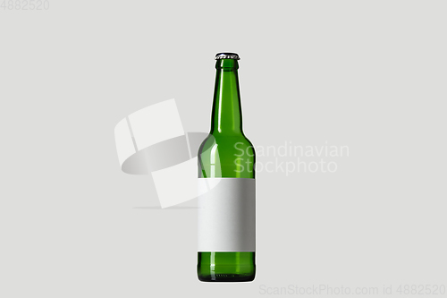 Image of Empty green colored beer bottle. Isolated on white studio background