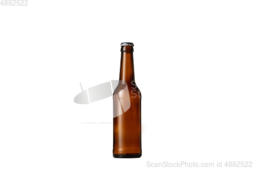 Image of Empty golden colored beer bottle. Isolated on white studio background