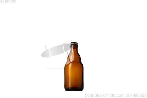 Image of Empty golden colored beer bottle. Isolated on white studio background
