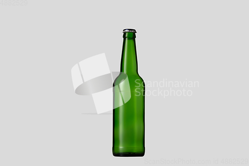 Image of Empty green colored beer bottle. Isolated on white studio background