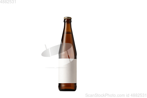 Image of Empty golden colored beer bottle. Isolated on white studio background