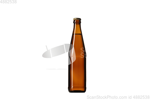Image of Empty golden colored beer bottle. Isolated on white studio background