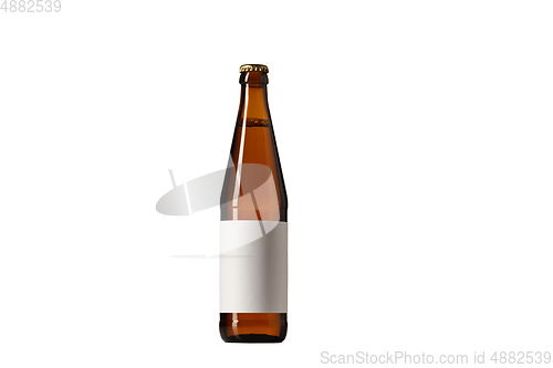 Image of Empty golden colored beer bottle. Isolated on white studio background