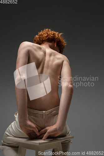 Image of Portrait of beautiful redhead man isolated on grey studio background. Concept of beauty, skin care, fashion and style