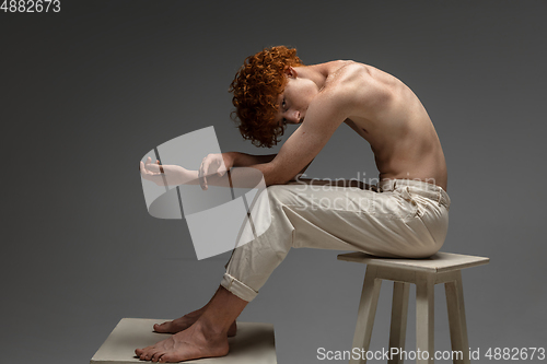 Image of Portrait of beautiful redhead man isolated on grey studio background. Concept of beauty, skin care, fashion and style