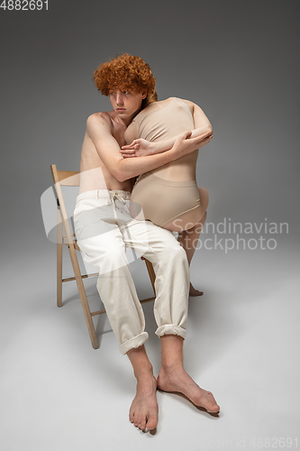 Image of Portrait of beautiful redhead couple isolated on grey studio background. Concept of beauty, skin care, fashion and style