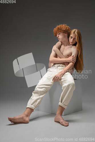 Image of Portrait of beautiful redhead couple isolated on grey studio background. Concept of beauty, skin care, fashion and style