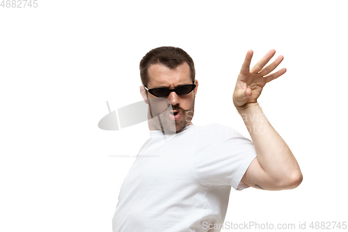 Image of Young caucasian man with funny, unusual popular emotions and gestures isolated on white studio background