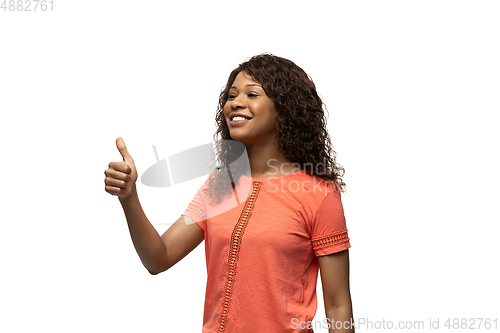 Image of Young african-american woman with funny, unusual popular emotions and gestures isolated on white studio background