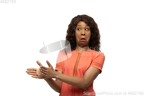 Image of Young african-american woman with funny, unusual popular emotions and gestures isolated on white studio background