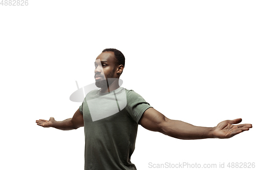 Image of Young african-american man with funny, unusual popular emotions and gestures isolated on white studio background