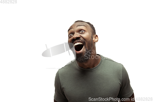 Image of Young african-american man with funny, unusual popular emotions and gestures isolated on white studio background