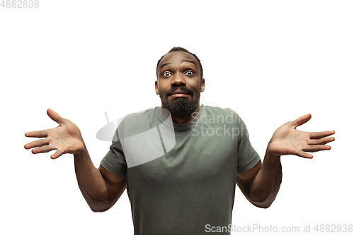 Image of Young african-american man with funny, unusual popular emotions and gestures isolated on white studio background