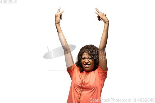 Image of Young african-american woman with funny, unusual popular emotions and gestures isolated on white studio background