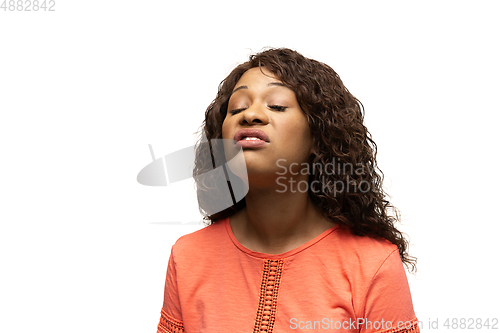 Image of Young african-american woman with funny, unusual popular emotions and gestures isolated on white studio background