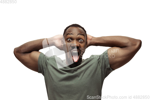 Image of Young african-american man with funny, unusual popular emotions and gestures isolated on white studio background