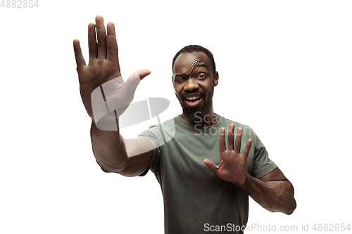 Image of Young african-american man with funny, unusual popular emotions and gestures isolated on white studio background