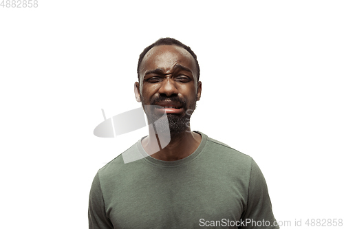 Image of Young african-american man with funny, unusual popular emotions and gestures isolated on white studio background