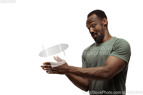 Image of Young african-american man with funny, unusual popular emotions and gestures isolated on white studio background