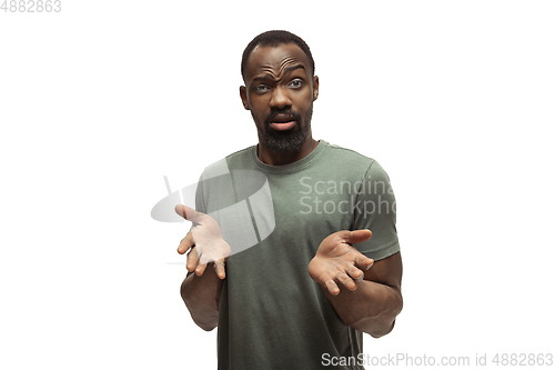 Image of Young african-american man with funny, unusual popular emotions and gestures isolated on white studio background