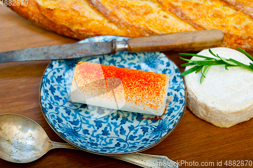Image of French cheese and fresh  baguette on a wood cutter