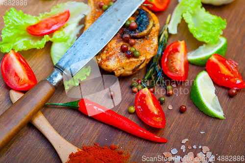 Image of wood fired hoven cooked chicken breast on wood board