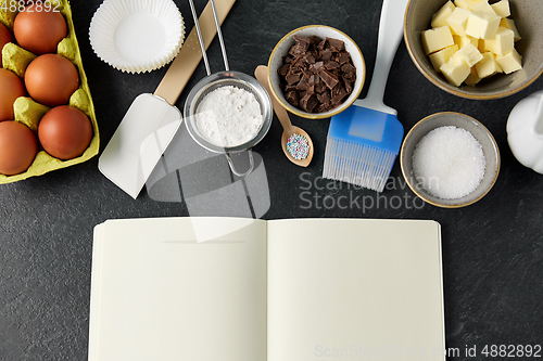 Image of recipe book and cooking ingredients on table